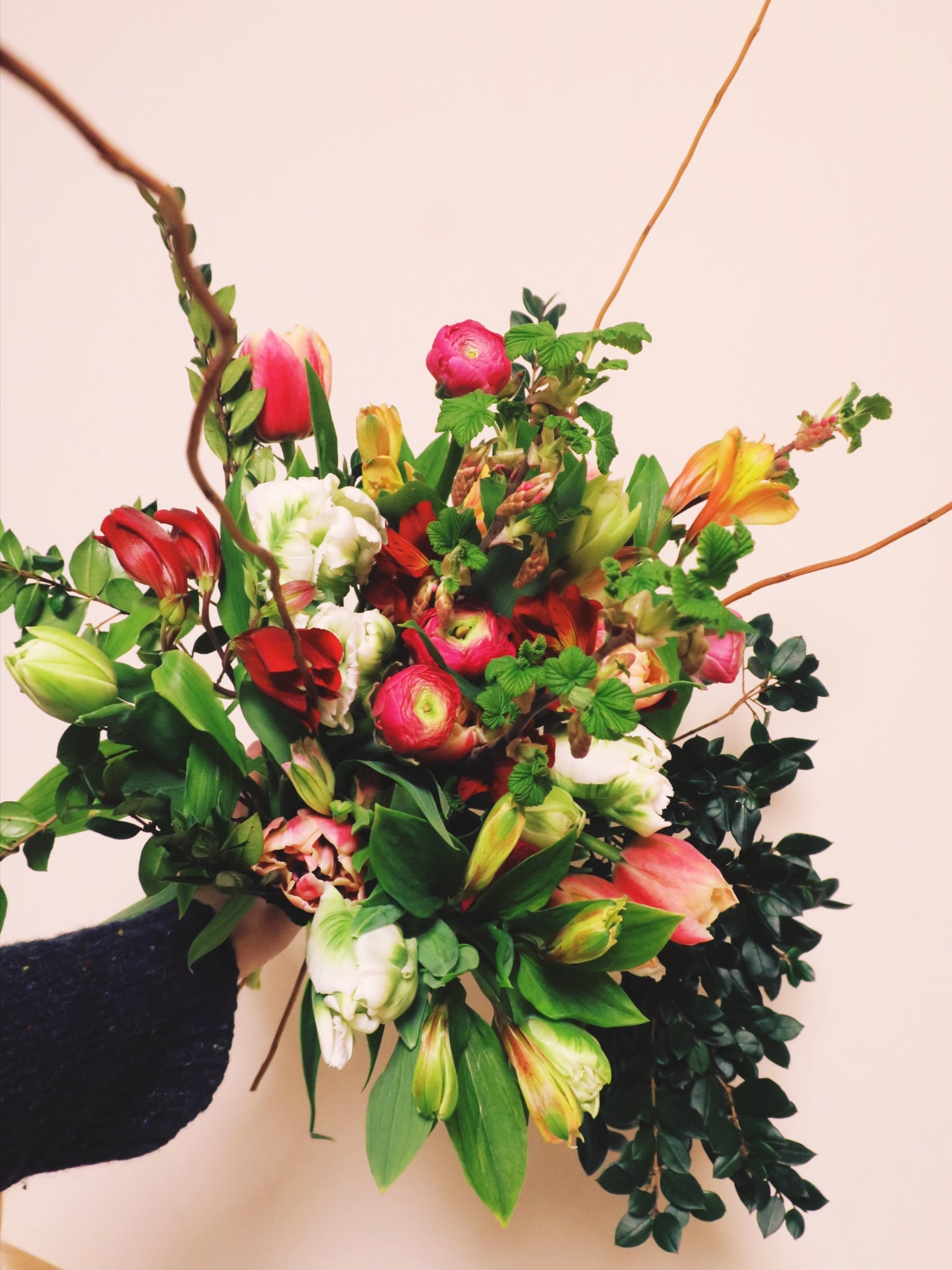 bunch of british grown and sustainable flowers. bouquet contains pink flowers and lots of greenery